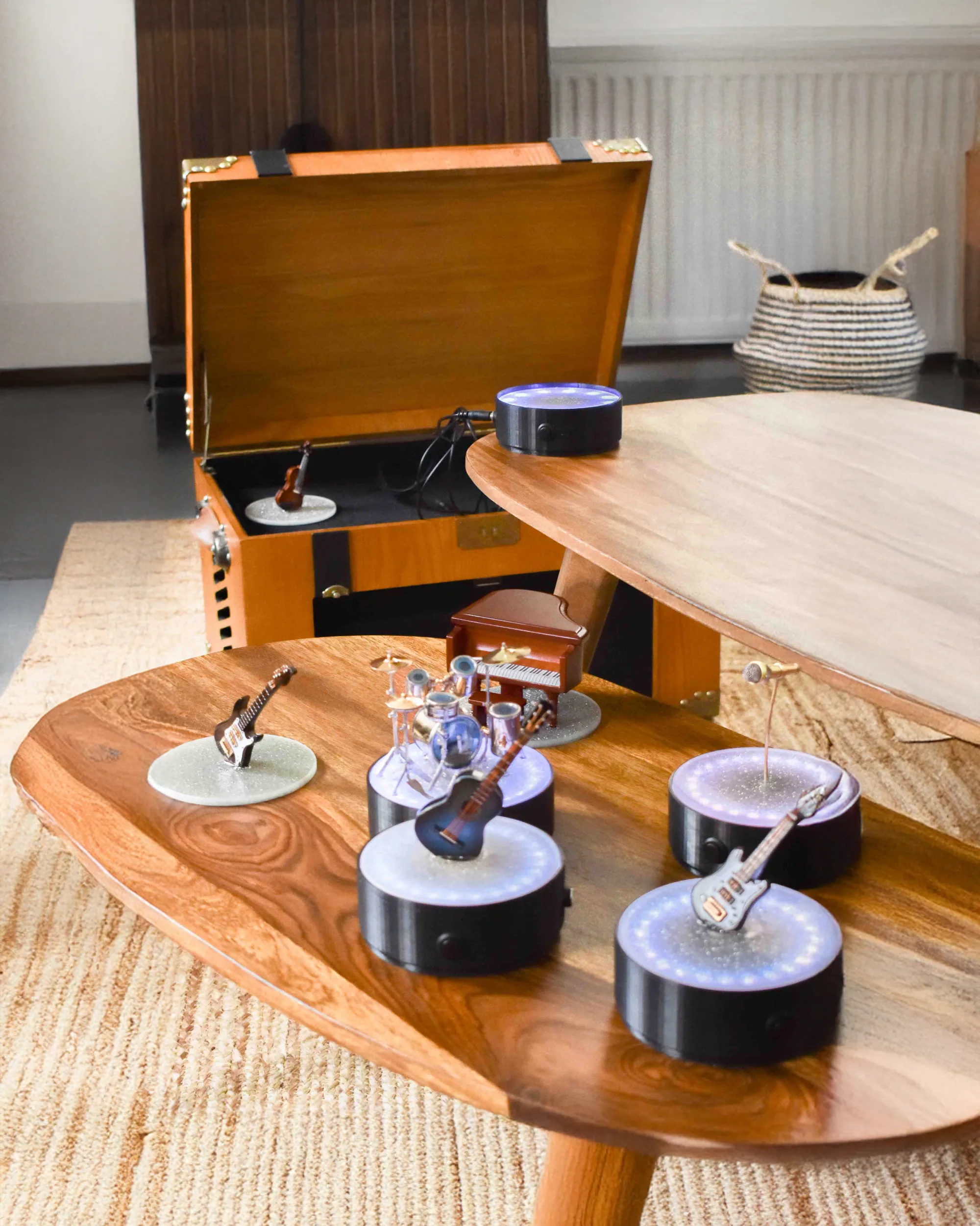 Miniature instrument figures on glowing satellite stations arranged on a wooden table