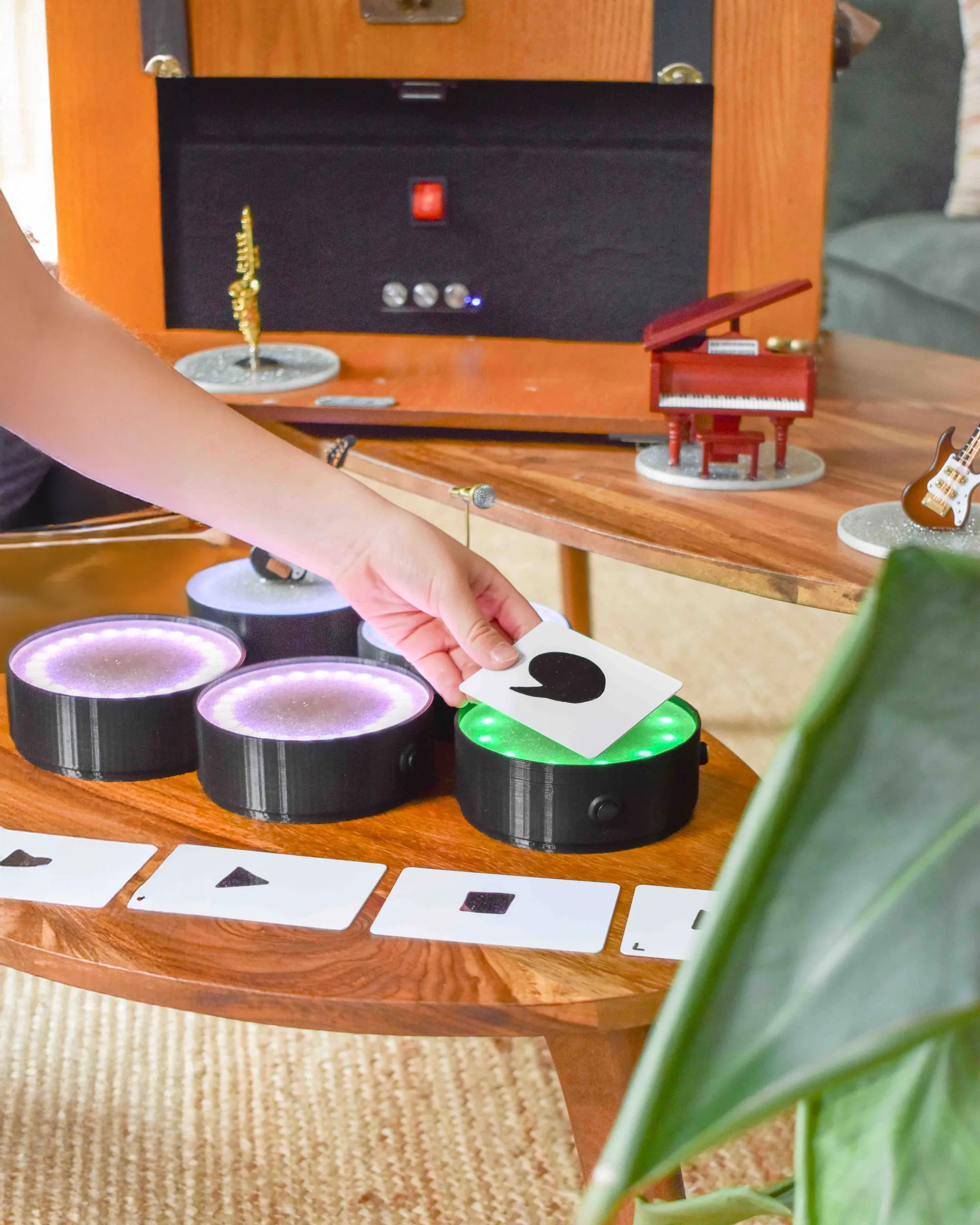 A child placing a function card on a glowing satellite station while miniature instruments sit on the table